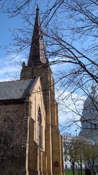 Grace Episcopal Church's historic steeple, seen with the Wisconsin State Capitol Building in the background.